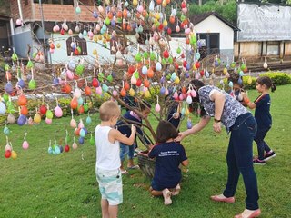 Meninos e meninas escolares brincam com os coelhinhos em Marechal Floriano 2