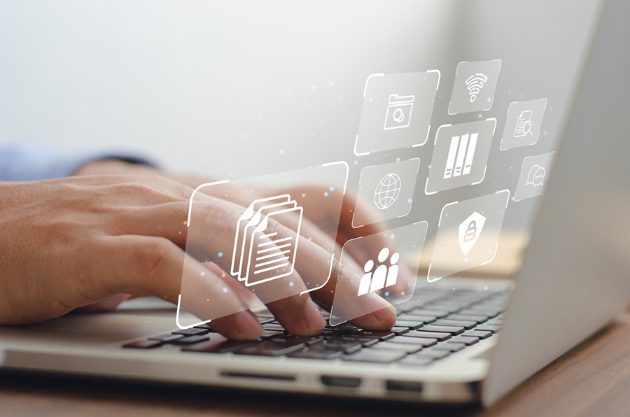 a business man using a computer to manage documents online document communication database and digital file storage systems/software record keeping database technology file a business man using a computer to manage documents online document communication database and digital file storage systems/software record keeping database technology file