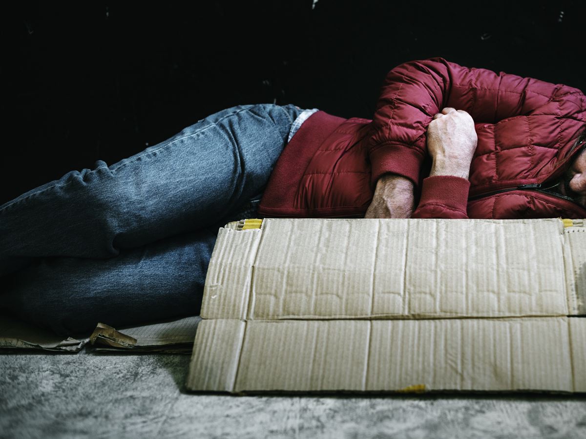 Homeless man sleeping out in the cold