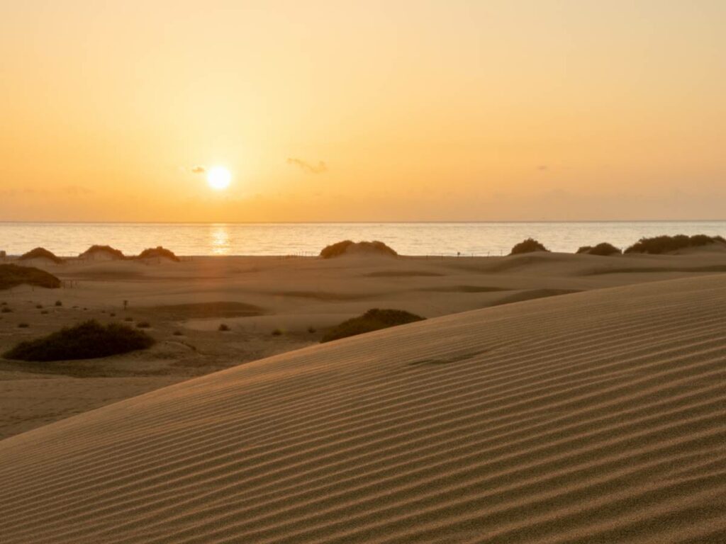 Early morning relaxing calm sunrise in the dunes of Maspalomas, Gran Canaria in the summer