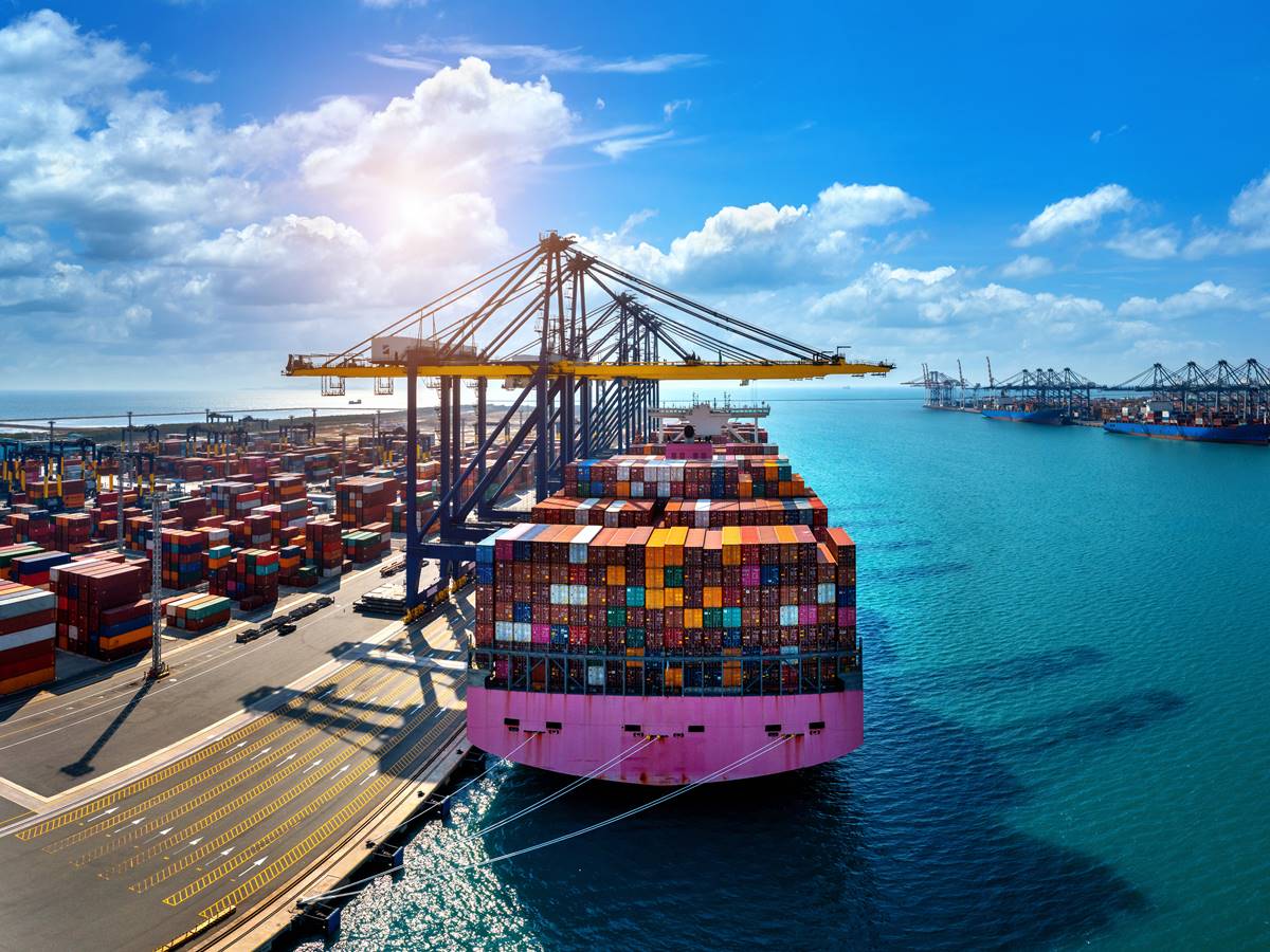 Aerial view of cargo ship and cargo container in harbor. Aerial view of cargo ship and cargo container in harbor.