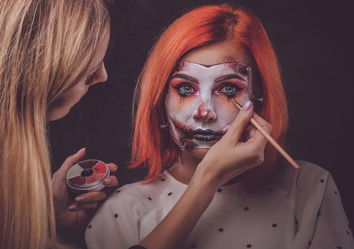 Makeup artist is creating scary art for Halloween Talented makeup artist is creating special scary Halloween art on woman's face.