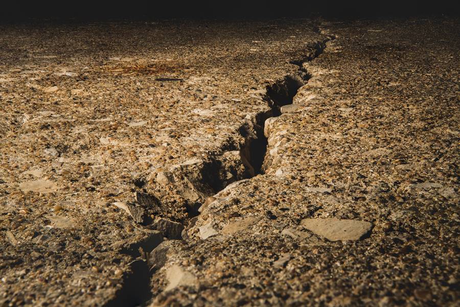 Split ground covered in stones under the sunlight with a blurry background A split ground covered in stones under the sunlight with a blurry background