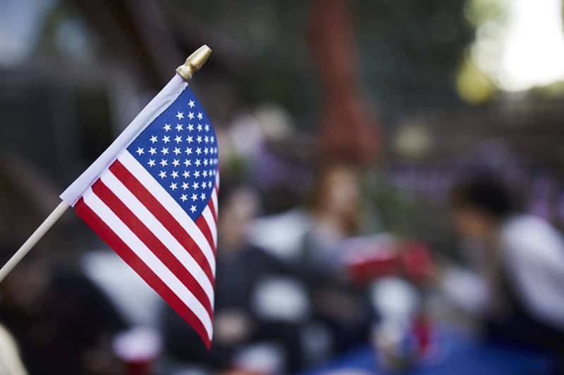 blurry-people-celebrating-with-american-flag blurry-people-celebrating-with-american-flag
