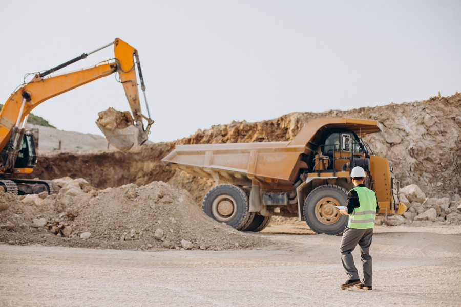 Male worker with bulldozer in sand quarry Male worker with bulldozer in sand quarry