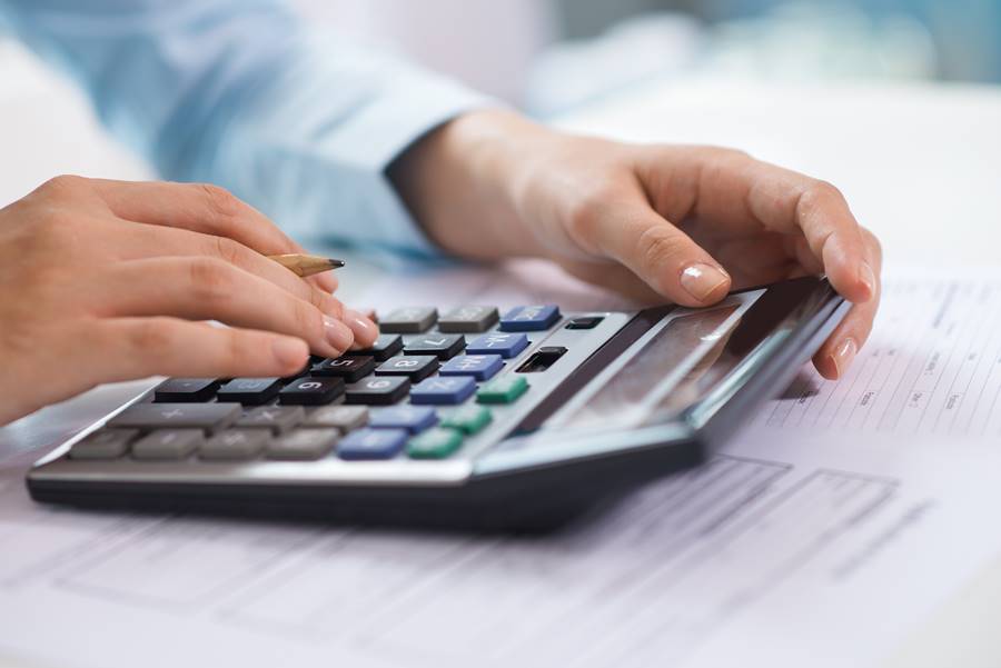 Closeup of economist working and counting data on calculator Closeup of economist working and counting data on calculator. Person pressing buttons. Finance concept. Cropped view.