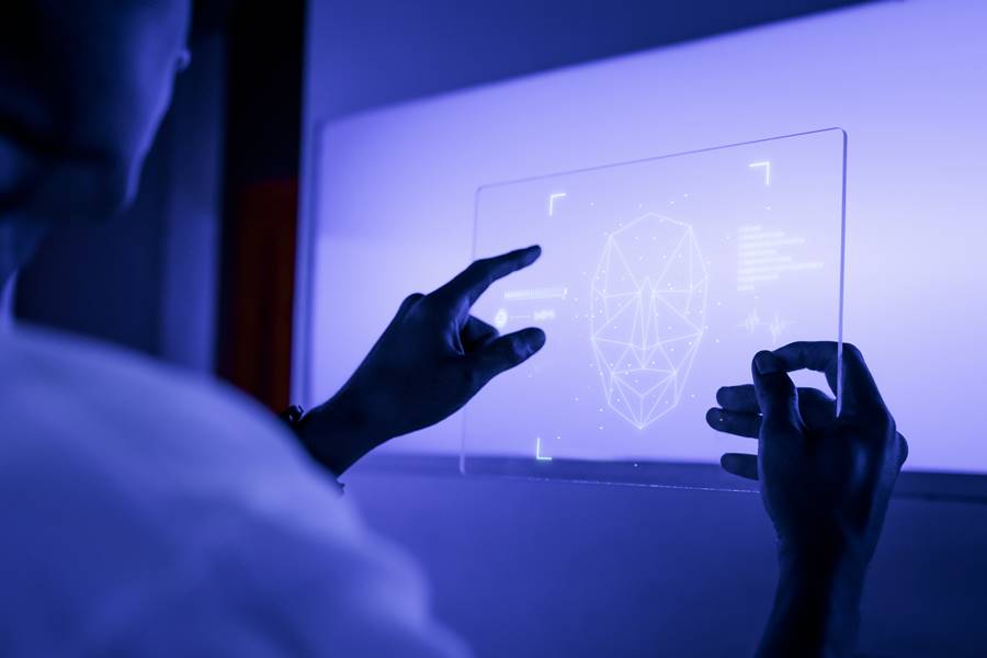 Designer using a transparent digital tablet screen futuristic te Designer using a transparent digital tablet screen futuristic technology