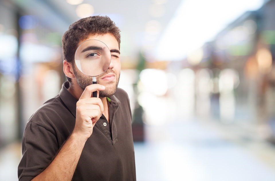 man-with-magnifying-glass-shopping-center