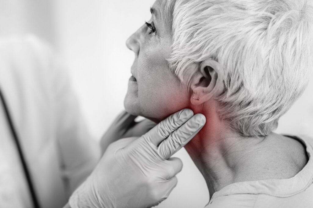 Thyroid gland control. Endocrinology doctor examining senior woman at a clinic.