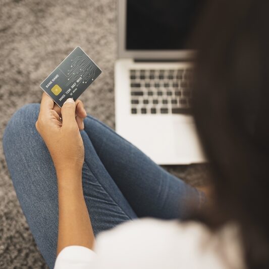 back-view-woman-holding-credit-card-floor