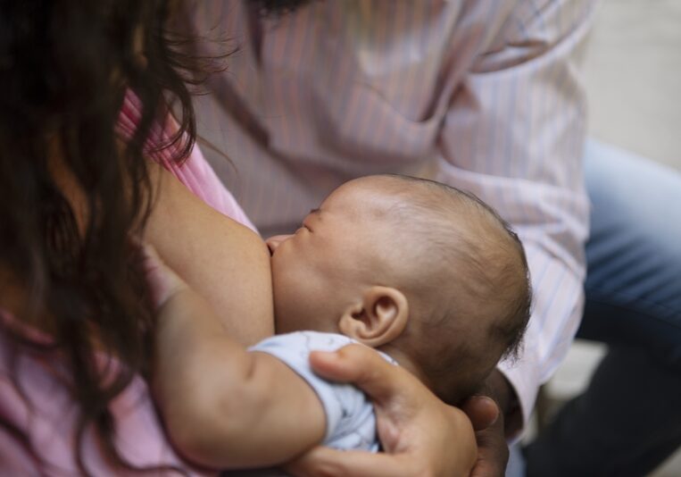 high-angle-woman-breastfeeding
