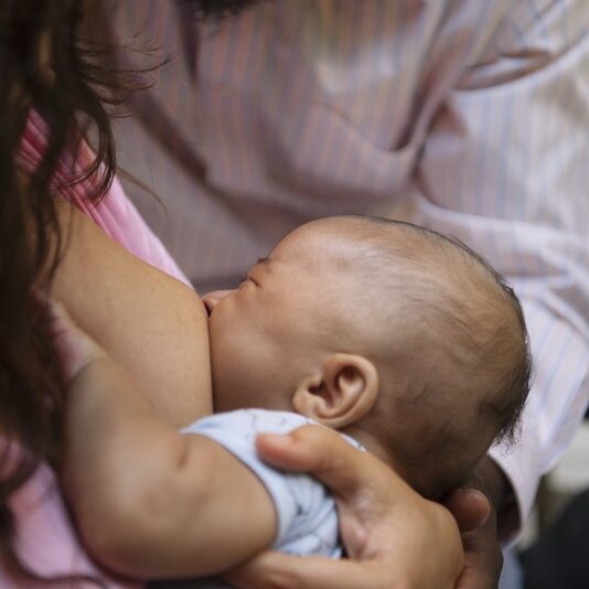 high-angle-woman-breastfeeding