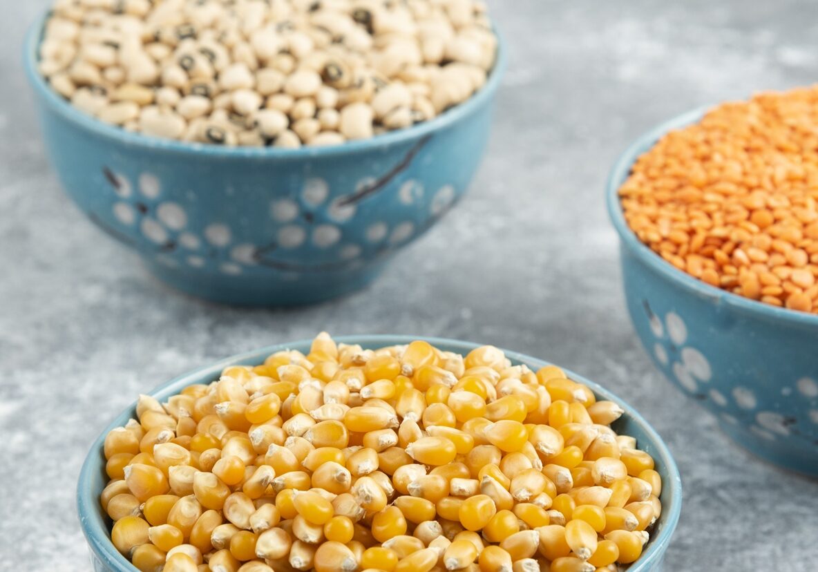 Raw red lentils, corns and white beans in blue bowls. High quality photo