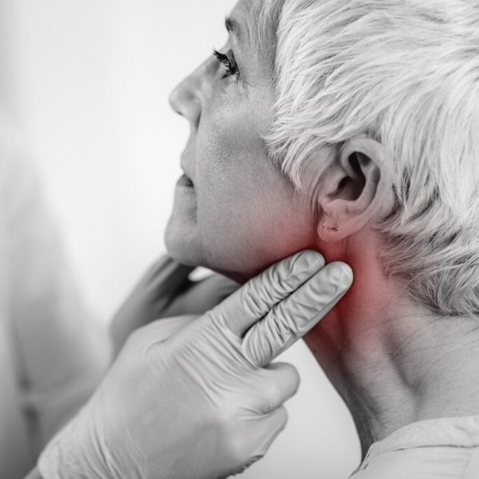 Thyroid gland control. Endocrinology doctor examining senior woman at a clinic.