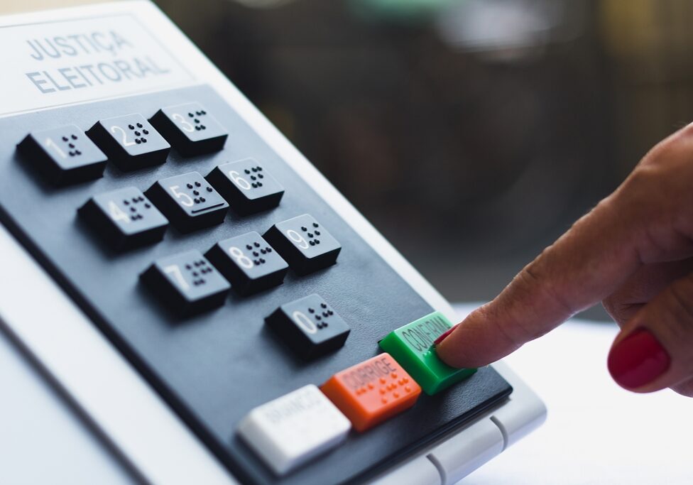 November 16, 2020, Brazil. In this photo illustration a woman simulates a vote in the electronic ballot box used in the elections of Brazil